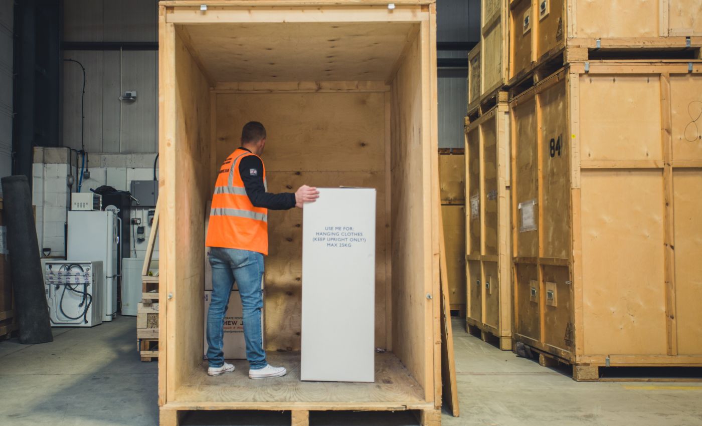 Professional placing belongings into a storage cell