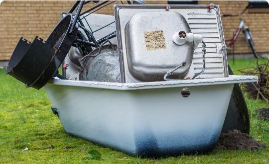 A pile of bathroom items left for disposal outside a property.